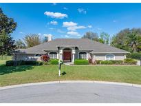 Charming single-story home featuring a well-manicured lawn and tasteful landscaping at 2024 Count Ct, Lakeland, FL 33813
