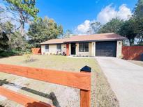 Charming, renovated ranch-style home featuring a well-maintained front yard and a freshly painted exterior at 1897 West Pkwy, Deland, FL 32724