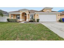 Charming single Gathering home featuring a well-maintained lawn and inviting curb appeal at 2726 Herons Landing Dr, Kissimmee, FL 34741