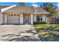 Charming single-story home with attached garage, well-maintained lawn, and inviting front entrance at 5054 Fairfield Dr, Lakeland, FL 33811