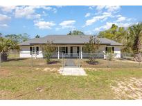 Charming single-story home featuring a manicured lawn and a secure chain-link fence for added privacy at 15675 Sw 33Rd St, Ocala, FL 34481
