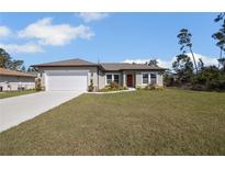 Charming single Gathering home features a well-manicured lawn and attached garage at 524 Marion Oaks Blvd, Ocala, FL 34473