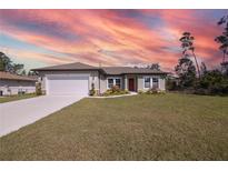 Charming single-story home featuring a well-manicured lawn, and a two-car garage at 524 Marion Oaks Blvd, Ocala, FL 34473