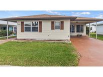 Charming single story home with well-maintained lawn and neutral siding with brown shutters at 4846 Colonnades Club Blvd, Lakeland, FL 33811