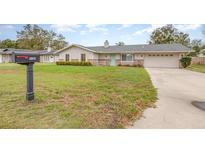 Charming single-story home with mailbox, manicured lawn, and two-car garage at 5105 Se 25Th St, Ocala, FL 34480