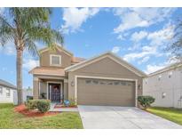 Charming two-story home featuring a well-maintained lawn and a two car garage with a cozy front entrance at 1724 Holton Rd, Lakeland, FL 33810