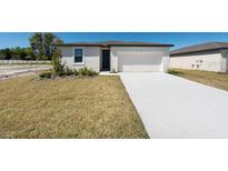Charming single-story home featuring a well-maintained lawn and a concrete driveway leading to a two-car garage at 1321 Oak Valley Dr, Auburndale, FL 33823