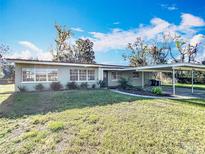 Charming single-story home with a covered carport and well-maintained lawn at 305 Bearcreek Dr, Bartow, FL 33830