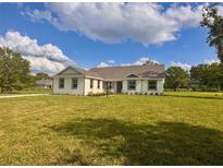 Charming single-story home with a well-maintained lawn and bright exterior at 2569 Rogers Rd, Lakeland, FL 33812