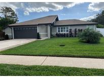 Charming single-story home boasts a well-manicured lawn, neutral stucco, and a two-car garage at 223 W Panama Rd, Winter Springs, FL 32708