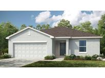 Charming single-story home featuring a two-car garage and neutral-tone exterior at 2675 Fern Leaf St, Auburndale, FL 33823