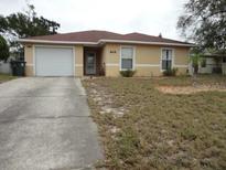 Charming single-story home with a driveway, front lawn and a one-car garage at 605 Van Ness St, Daytona Beach, FL 32114