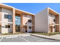 Modern townhouse exterior with large windows and neutral color scheme against blue sky at 7540 Brooklyn Dr, Kissimmee, FL 34747