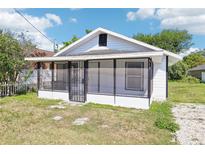 Charming single-story home with a screened porch and a well-maintained, small front yard at 515 9Th St, Winter Garden, FL 34787