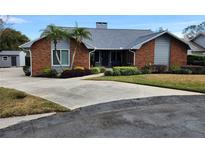 Charming single-Gathering home with manicured landscaping, brick accents and a concrete driveway at 608 Palmore Ct, Lakeland, FL 33813