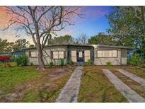 Charming single-story home with a well-maintained lawn and mature landscaping at 1625 Crystal E Ct, Lakeland, FL 33801