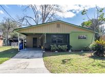 Charming single-story home with a covered carport and screened in porch at 1016 W 12Th St, Lakeland, FL 33805