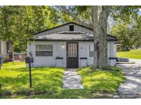 Charming single story home with fresh green lawn and mature tree at 828 W 13Th St, Lakeland, FL 33805