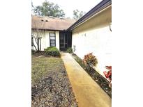 Inviting front entrance featuring a tiled walkway leading to the front door of the home at 3881 Villa Rose Ln, Orlando, FL 32808