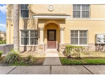 Charming yellow two-story home with a covered front entrance and a well-maintained yard at 5331 River Rock Rd, Lakeland, FL 33809