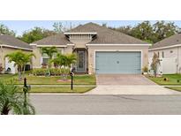 Charming single-story home with a well-manicured lawn and a two-car garage and nicely landscaped at 4763 Riverwalk Dr, St Cloud, FL 34771