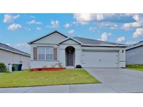 Charming one-story home with a well-manicured lawn and neutral color palette at 1040 Cambridge Drive, Winter Haven, FL 33881
