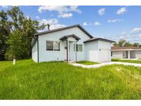 Charming home featuring a modern design, manicured lawn, and inviting curb appeal at 2216 W Lanier St, Lakeland, FL 33815