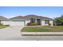 Charming single-story home with a well-manicured lawn and an attached two-car garage at 524 Buckshot Ln, Lakeland, FL 33809