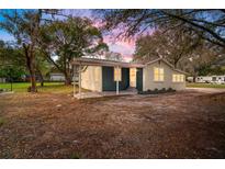 Charming single-story home featuring a covered entrance, painted brickwork, and a well-maintained yard at 820 N Carroll Rd, Lakeland, FL 33801