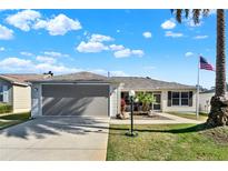 Charming single-story home showcasing well-maintained lawn, two-car garage, and inviting landscaping at 2337 St George Ave, The Villages, FL 32162