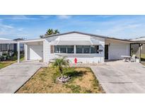 Charming single-story home featuring a well-maintained yard and a cozy covered entrance at 5006 Lodgewood Dr, Lakeland, FL 33810