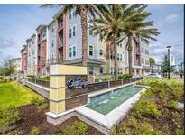 Beautiful condo building with palm trees and water feature at Gatherings of Lake Nona at 7517 Laureate Blvd # 4303, Orlando, FL 32827