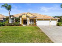 Charming single-story home with tile roof, well-manicured lawn and lush landscaping with a convenient two car garage at 11321 Ledgement Ln, Windermere, FL 34786