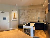 Contemporary kitchen boasts a spacious island, modern appliances, and a cozy bench nook at 3151 Sunset Walk Dr # 314, Kissimmee, FL 34747