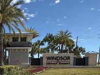 Welcoming Windsor Island Resort entrance with manicured landscaping, palm trees, and prominent signage under a sunny sky at 627 Jasmine Ln, Davenport, FL 33897