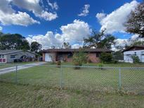 Charming single-story brick home featuring a spacious front yard with chain link fence at 2865 Barton Pl, Bartow, FL 33830