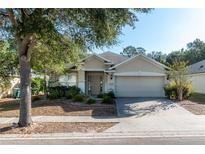Charming single-story home with a well-manicured lawn and an attached two-car garage at 4067 Sw 46Th Ter, Ocala, FL 34474
