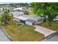 Charming single Gathering home featuring mature landscaping and a metal roof in a quiet neighborhood at 1629 Lauren Ln, Lady Lake, FL 32159