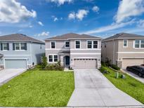 Two-story home with landscaped yard, neutral color palette and a two car garage at 8923 Sw 50Th Ave, Ocala, FL 34476