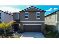 Two-story home showcasing its neutral-toned exterior and attached two-car garage at 2244 Teneroc Trl, Lakeland, FL 33805