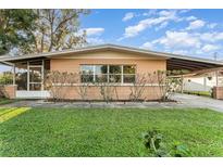 Charming single-story home with a covered carport and screened in porch at 520 S Orange Ave, Fort Meade, FL 33841