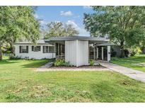 Attractive single-story home with clean lines, modern windows, and a well-manicured lawn at 407 W Oak Dr, Lakeland, FL 33803