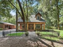 Charming home featuring stone accents, a welcoming front porch, and a beautifully landscaped front yard at 4845 Sw 78Th Ave, Bushnell, FL 33513