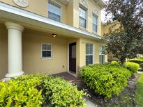 Inviting front entrance with a cream pillar, a decorative door and well-maintained landscaping at 5335 River Rock Rd, Lakeland, FL 33809