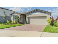 Charming single-story home with manicured landscaping and brick paved driveway at 928 Cambridge Dr, Winter Haven, FL 33881
