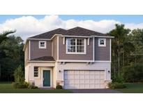 Charming two-story home with gray siding, a two-car garage, a teal front door, and lush surrounding landscaping at 5103 Bridgehaven Rd, Davenport, FL 33837