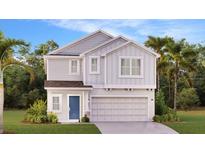 Charming two-story home featuring a light gray exterior, a blue door and a well-manicured lawn at 5618 Gingham Dr, Kissimmee, FL 34758