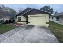 Charming single-story home with an attached garage and well-maintained front yard at 669 Eagle Run, Lakeland, FL 33809