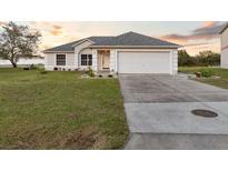 Charming single-story home features a well-maintained lawn and attached two-car garage at 25 Inconnu Dr, Kissimmee, FL 34759