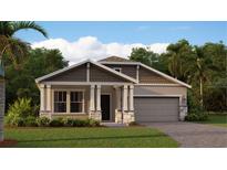 Charming single-Gathering home features stone accents, two-car garage, inviting front porch, and well-maintained landscaping at 4117 Jespersen St, Apopka, FL 32712